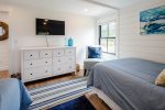 Bedroom with two double beds, dresser and 40 flatscreen TV